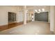 Spacious living room with hardwood floors, pillars, and large windows at 2472 W Peakview Ct, Littleton, CO 80120