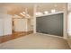 Open living room featuring skylights, carpet, and neutral tones at 2472 W Peakview Ct, Littleton, CO 80120