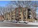 Apartment building exterior with brick facade, multiple windows, and street parking at 500 E 11Th Ave # 401, Denver, CO 80203