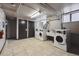 A convenient laundry room is equipped with multiple machines and a sink for easy washing at 500 E 11Th Ave # 401, Denver, CO 80203