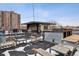 A charming rooftop patio features comfortable seating and panoramic views of the surrounding buildings at 500 E 11Th Ave # 401, Denver, CO 80203