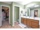 Bathroom featuring a dual sink vanity, tile floors, and a door to the walk-in closet at 801 S 15Th Ave, Brighton, CO 80601