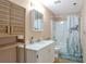 Bathroom featuring a vanity, medicine cabinet, shower/tub combo, and wood shelf at 801 S 15Th Ave, Brighton, CO 80601