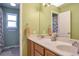 Bathroom featuring a dual sink vanity and a door to the shower at 801 S 15Th Ave, Brighton, CO 80601