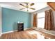 Well-lit bedroom with hardwood floors, ceiling fan, and windows, creating a cozy and comfortable retreat at 801 S 15Th Ave, Brighton, CO 80601