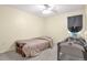 Cozy bedroom features a ceiling fan and neutral carpeting and paint at 801 S 15Th Ave, Brighton, CO 80601