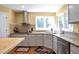 Updated kitchen featuring stainless steel appliances, granite countertops, and wood-look flooring at 801 S 15Th Ave, Brighton, CO 80601