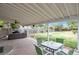 Relaxing covered patio features a ceiling fan, comfortable seating, and views of the private yard at 801 S 15Th Ave, Brighton, CO 80601