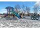 Colorful playground equipment in snowy setting, including slides and climbing structures at 4201 Beautiful Cir, Castle Rock, CO 80109