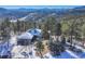 Aerial view of house with mountain backdrop at 25060 Montane Drive West, Golden, CO 80401