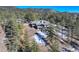 Aerial view of house nestled in snowy mountainside at 25060 Montane Drive West, Golden, CO 80401