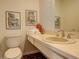 Clean bathroom with updated vanity, toilet and brick flooring at 25060 Montane Drive West, Golden, CO 80401