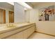 Bathroom with double vanity and large mirror at 25060 Montane Drive West, Golden, CO 80401