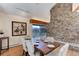 Dining room with stone fireplace and views, features a wood table and neutral chairs at 25060 Montane Drive West, Golden, CO 80401