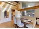 Spacious dining area with a wood table and light-colored chairs near a large window at 25060 Montane Drive West, Golden, CO 80401