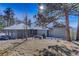 House exterior showcasing a snow covered yard at 25060 Montane Drive West, Golden, CO 80401