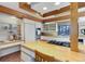 Kitchen with wood countertop and white cabinetry at 25060 Montane Drive West, Golden, CO 80401