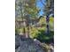 Landscaped backyard with trees and rocks at 25060 Montane Drive West, Golden, CO 80401