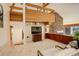 Living room with a stone fireplace and built-in media cabinet at 25060 Montane Drive West, Golden, CO 80401