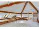 Spacious loft area with wood beams, skylights, and built-in shelving at 25060 Montane Drive West, Golden, CO 80401