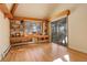 Home office with built-in bookshelves and hardwood floors, near a sliding glass door at 25060 Montane Drive West, Golden, CO 80401