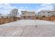 Large, snow-covered backyard with wood fence and view of the home at 24285 E Wagon Trail Ave, Aurora, CO 80016