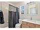 Clean bathroom with modern fixtures, gray shower curtain and vanity at 24285 E Wagon Trail Ave, Aurora, CO 80016