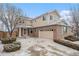 Charming two-story brick and siding home with a two-car garage and driveway at 24285 E Wagon Trail Ave, Aurora, CO 80016