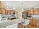 Spacious kitchen with granite counters, stainless appliances, pendant lights, and hardwood floors at 24285 E Wagon Trail Ave, Aurora, CO 80016