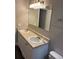 Bathroom featuring a double vanity with dual sinks and a large mirror above, providing ample space at 1222 Yosemite St, Denver, CO 80220