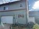 Home with garage and partial view of backyard with fence and AC unit at 1222 Yosemite St, Denver, CO 80220