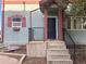 Charming home entrance with concrete steps, wrought iron railing, and well-maintained landscaping at 1222 Yosemite St, Denver, CO 80220