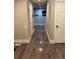 Hallway with wood-look flooring, white trim, and several doors leading to other rooms in the house at 1222 Yosemite St, Denver, CO 80220