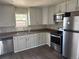 Well lit kitchen featuring stainless steel appliances, grey cabinets and a double basin sink at 1222 Yosemite St, Denver, CO 80220