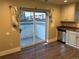 Kitchen area with stainless steel appliances and access to an outdoor patio through sliding glass doors at 1222 Yosemite St, Denver, CO 80220