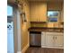 Kitchen area featuring a stainless steel dishwasher, double sink, and access to an outdoor space at 1222 Yosemite St, Denver, CO 80220