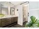 Modern bathroom with double vanity, tiled floor, and updated glass shower at 6305 W 6Th Ave # C12, Lakewood, CO 80214