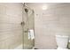 Bright bathroom features tiled shower with glass door, tile walls and modern fixtures at 6305 W 6Th Ave # C12, Lakewood, CO 80214