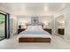 Bright bedroom features a queen-size bed, soft carpet, and a sliding glass door for outdoor access at 6305 W 6Th Ave # C12, Lakewood, CO 80214