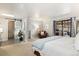 Primary bedroom featuring en-suite bathroom, sliding glass door, and peaceful decor at 6305 W 6Th Ave # C12, Lakewood, CO 80214