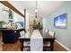 Dining room with large table, hardwood floors, and ample natural light in an open concept space at 6305 W 6Th Ave # C12, Lakewood, CO 80214