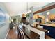 Open-concept dining room with hardwood floors, light walls, and seamlessly connected to kitchen and living areas at 6305 W 6Th Ave # C12, Lakewood, CO 80214