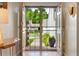 A bright entryway with a view of the outdoors through glass doors and modern decor at 6305 W 6Th Ave # C12, Lakewood, CO 80214