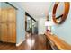 Bright hallway with wood floors, console table with decor, and an open view to other rooms at 6305 W 6Th Ave # C12, Lakewood, CO 80214