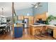 Spacious kitchen with wooden cabinets, an island with seating, and stainless steel appliances at 6305 W 6Th Ave # C12, Lakewood, CO 80214