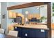 Bright kitchen with butcher block island, stainless appliances, light wood cabinets, and blue backsplash at 6305 W 6Th Ave # C12, Lakewood, CO 80214