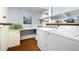 Well-equipped laundry room featuring ample counter space, overhead shelving, and modern washer and dryer units at 6305 W 6Th Ave # C12, Lakewood, CO 80214