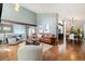 Spacious living room with hardwood floors, comfortable seating, and views into the dining and kitchen at 6305 W 6Th Ave # C12, Lakewood, CO 80214