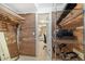 Organized walk-in closet featuring wood paneled walls and wire shelving for storage, alongside a full-length mirror at 6305 W 6Th Ave # C12, Lakewood, CO 80214