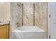 Bright bathroom featuring a tub with decorative tile and modern fixtures at 12711 Colorado Blvd # 714G, Thornton, CO 80241